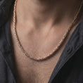 Load image into Gallery viewer, The rose gold plated Byzantine necklace is worn naturally on a man’s chest, showcasing its round interwoven chain structure, dimensional shine, and elegant masculine design.

