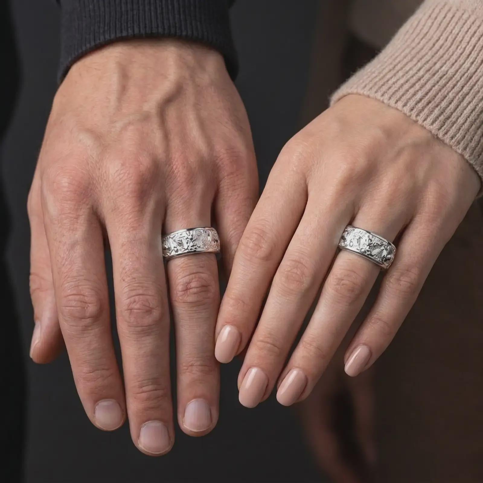 The polished silver dragon spinner band is worn naturally on a human hand, showing the sculptural Asian dragon design and refined spinning ring profile in a premium lifestyle photograph.