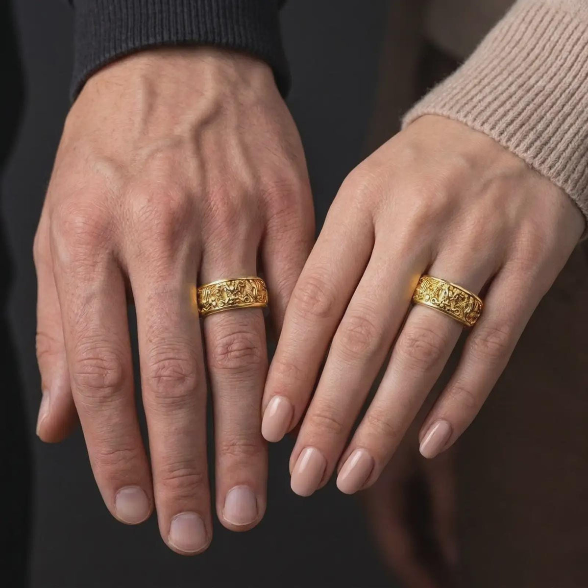 A gold plated serpent dragon spinner ring is worn on a human hand, highlighting the symbolic wisdom motif, engravable band design, and distinctive mystical wedding ring style in a refined close-up lifestyle shot.
