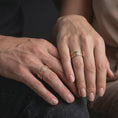 Load image into Gallery viewer, The rose gold plated Aztec spinner band is worn on a finger, showcasing the geometric engravings, rotating fidget ring structure, and elegant unisex jewelry profile.
