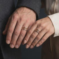 Load image into Gallery viewer, The rose gold plated scroll spinner band is worn on a finger, showcasing flowing botanical details, rounded edges, and an elegant unisex fidget ring design.
