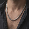 Load image into Gallery viewer, A 6mm Byzantine chain necklace with an oxidized finish is worn on a man’s neck, displaying dark recessed link details and a bold masculine silhouette in a close-up lifestyle shot.
