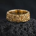 Load image into Gallery viewer, A gold plated Asian dragon band rests on rugged volcanic rock, showcasing the dimensional dragon head, curling whiskers, detailed scale work, and powerful fantasy-inspired relief in a luxury macro studio close-up.
