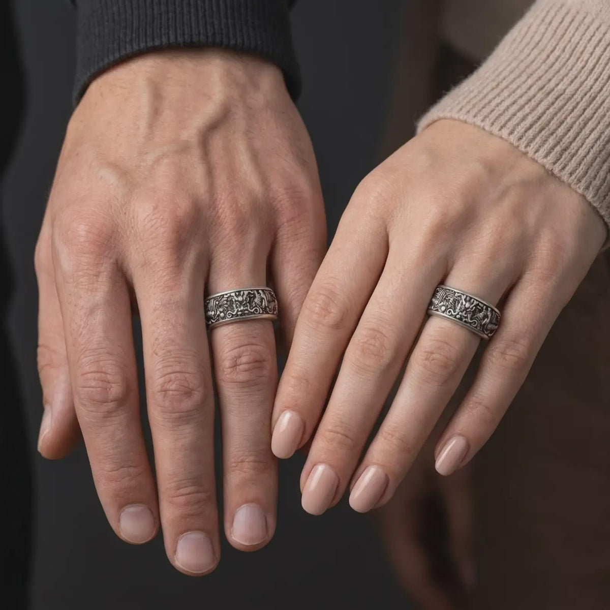 An oxidized Asian serpent dragon spinner ring is worn on a human hand, displaying the intricate dragon motif, dark recessed detailing, and bold sterling silver band in a close-up lifestyle shot.