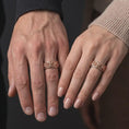 Load image into Gallery viewer, The rose gold plated Asian dragon spinner ring is worn on a human hand, showcasing the detailed dragon relief, smooth rounded edges, and elegant unisex fidget band appearance.

