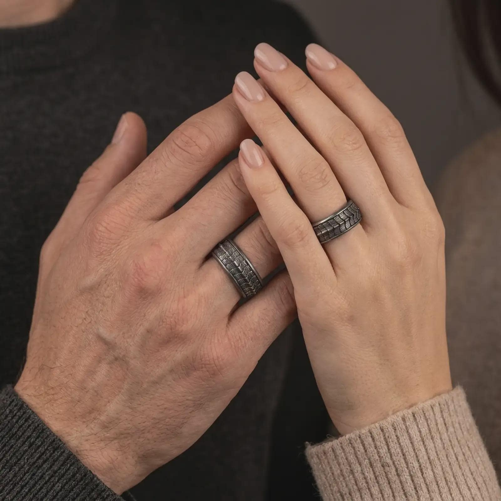 An oxidized sterling silver lizard scale spinner ring is worn on a human hand, showing the textured reptile pattern, rotating band detail, and bold unisex style in a lifestyle close-up.