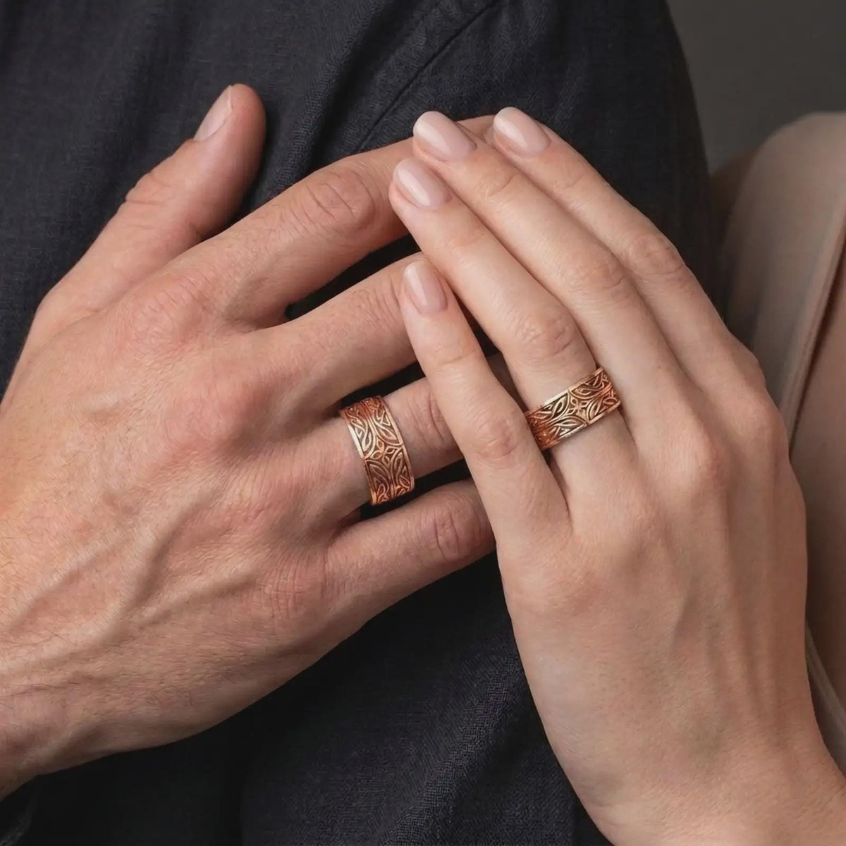 The rose gold plated Elven Star band is worn on a finger, showcasing the mystical geometric centerpiece, flowing interwoven details, rounded edges, and elegant unisex fantasy jewelry design.