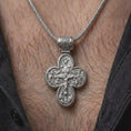 Load image into Gallery viewer, The polished silver Orthodox protection necklace is worn naturally on the neck, showing the Saint Michael side, elegant cross outline, and meaningful devotional jewelry style in a premium lifestyle photograph.
