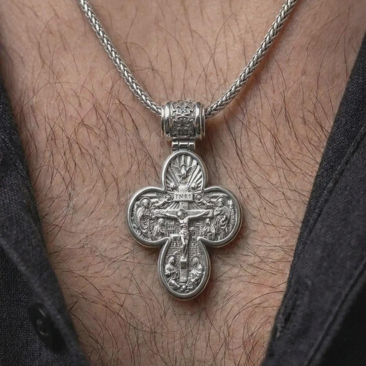 The polished silver Orthodox protection necklace is worn naturally on the neck, showing the Saint Michael side, elegant cross outline, and meaningful devotional jewelry style in a premium lifestyle photograph.
