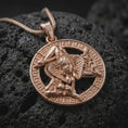 Load image into Gallery viewer, Rose gold plated Sicilian Trinacria necklace on black volcanic stone, highlighting the Medusa center, three-legged Sicily symbol, and detailed circular medallion design.
