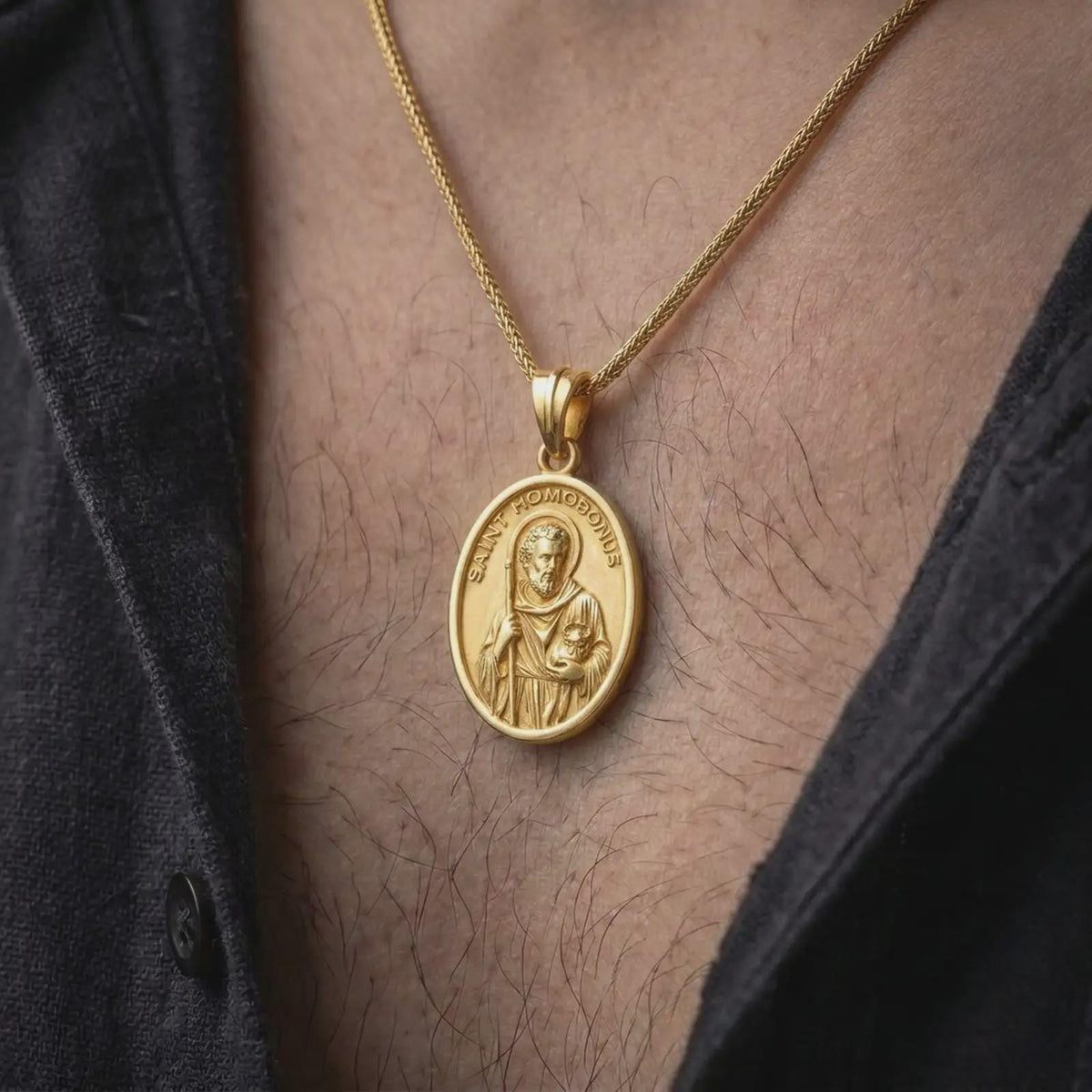 Gold plated Saint Homobonus necklace worn on the chest, highlighting the detailed saint portrait, halo, staff, and meaningful Catholic merchant patron design.