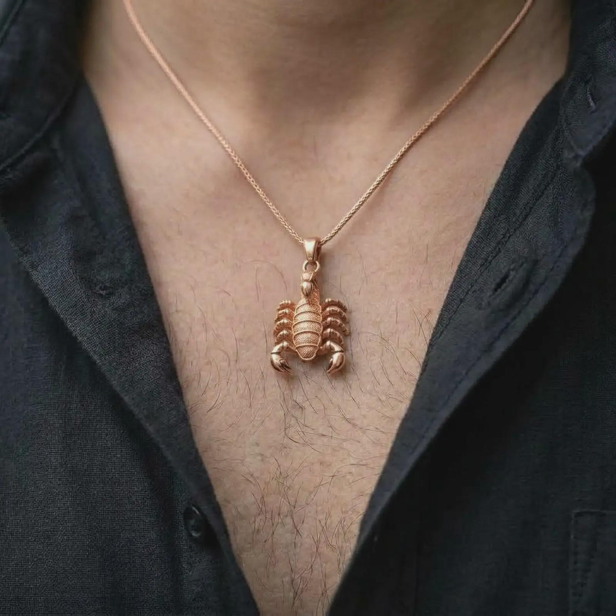 The rose gold plated scorpion pendant is worn on the chest, showcasing the sculptural claws, detailed legs, armored body, raised stinger, and bold unisex astrology-inspired jewelry style.
