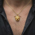 Load image into Gallery viewer, A gold plated ant head necklace is worn on the chest, highlighting the sculpted insect anatomy, textured eyes, articulated antennae, and bold gothic statement pendant profile in a refined lifestyle photograph.
