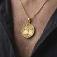Load image into Gallery viewer, A gold plated Yggdrasil necklace is worn on the chest, highlighting the sculptural Tree of Life, interconnected roots, spreading branches, and meaningful Viking-inspired symbolic jewelry design.
