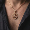 Load image into Gallery viewer, Rose gold plated Sicily Trinacria pendant worn on the chest, featuring the traditional Medusa and three-legged Triskelion design in a detailed circular medallion.
