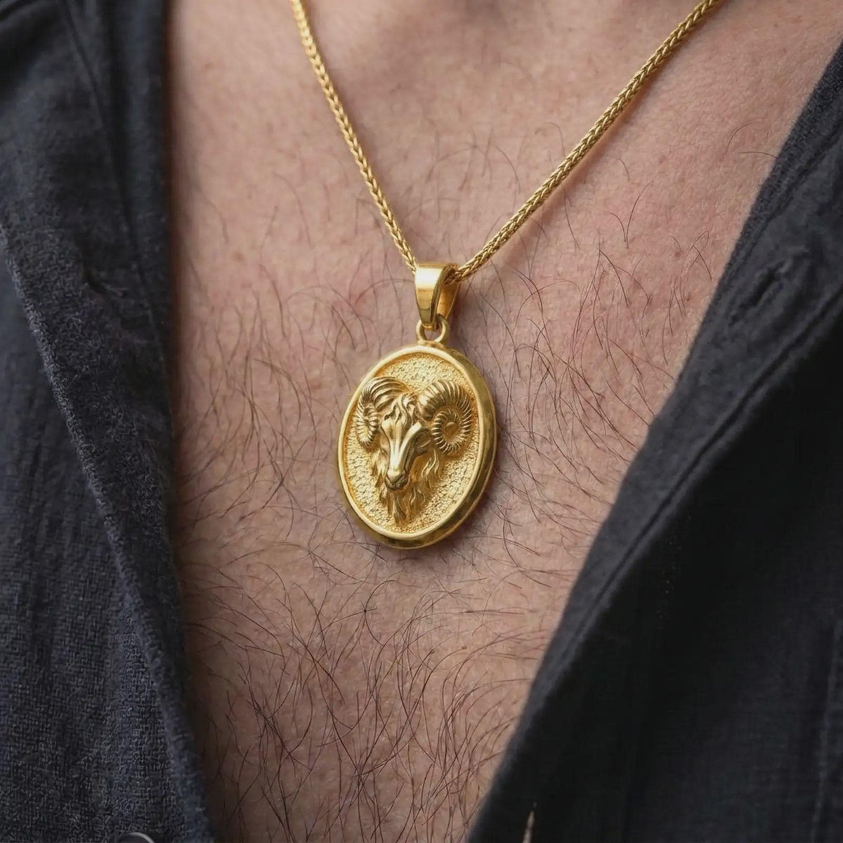 Gold plated Aries ram necklace worn on the chest, highlighting the powerful horned ram design, oval medallion shape, and meaningful astrology-inspired styling.