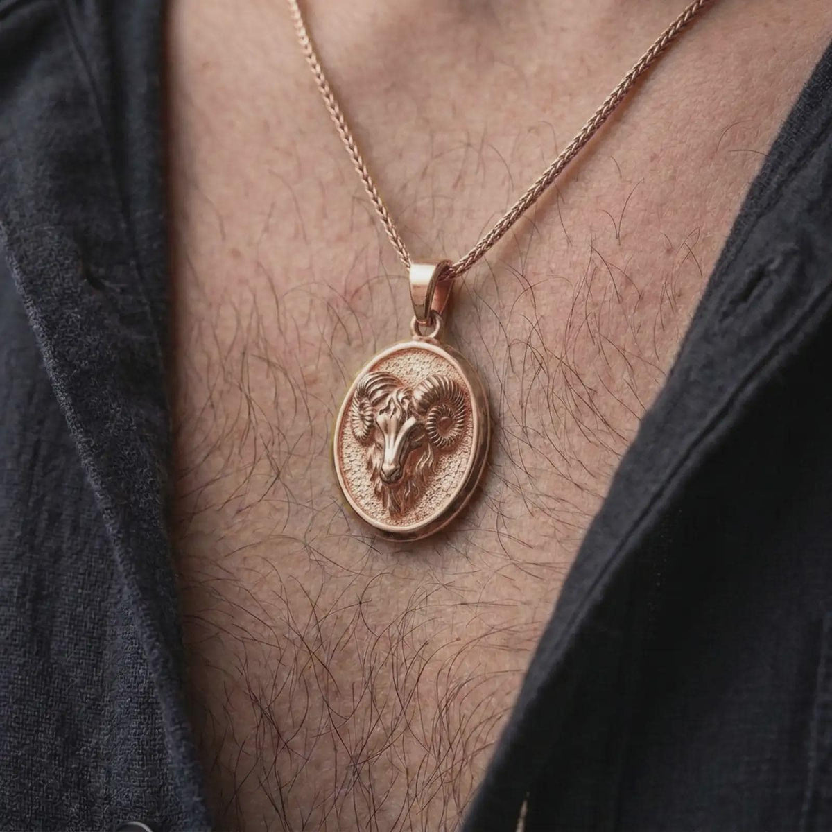 Rose gold plated Aries pendant worn on the chest, showcasing the detailed ram head, symmetrical spiral horns, and personalized zodiac necklace aesthetic.