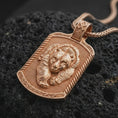 Load image into Gallery viewer, Rose gold plated bear and cub necklace displayed on textured volcanic stone, showcasing the detailed bear portraits, close parent-child composition, rope-style border, and wildlife pendant design.
