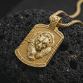 Load image into Gallery viewer, Gold plated bear family pendant resting on black volcanic rock, featuring a parent bear and cub nestled together with sculpted fur, textured background, and bold rectangular medallion frame.
