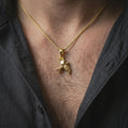 Load image into Gallery viewer, Gold plated swallow necklace worn on the chest, highlighting the origami-inspired bird form, angular wings, and symbolic freedom-inspired jewelry design.
