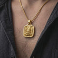 Load image into Gallery viewer, Gold plated Tlaloc rain god necklace worn on the chest, highlighting the sculpted deity face, geometric Aztec patterns, and bold Mexican mythology-inspired design.
