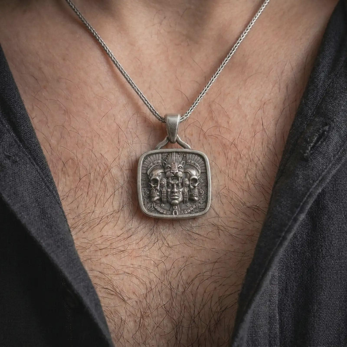 Oxidized sterling silver Aztec jaguar necklace worn on the chest, displaying the ceremonial face, skull details, feline headdress, and intricate Mesoamerican warrior-inspired design.