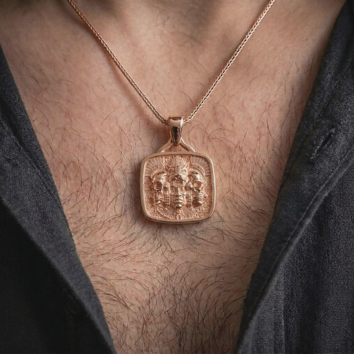 Rose gold plated Aztec skull necklace worn on the chest, showcasing jaguar imagery, sculpted skulls, feathered ornamentation, and a distinctive Mesoamerican statement design.