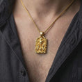 Load image into Gallery viewer, Gold plated demon skull necklace worn on the chest, highlighting the curled ram horns, open skull face, skeletal details, and dramatic biker-inspired styling.
