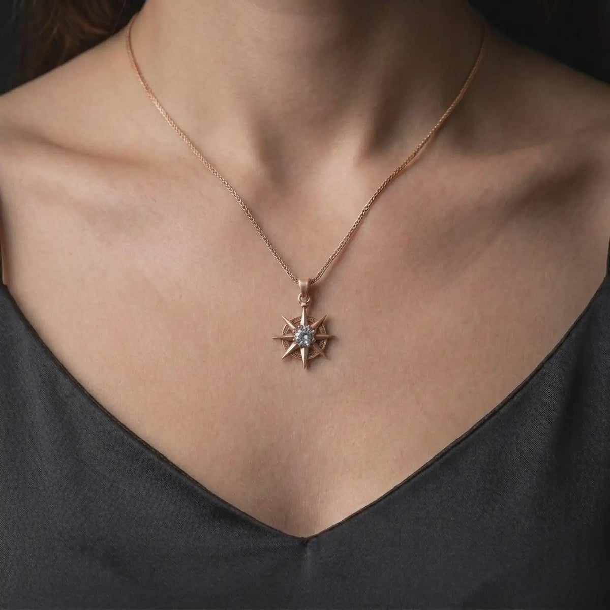 Rose gold plated Gale charm worn on the chest, showcasing the detailed star-shaped pendant, sparkling center stone, and Baldur's Gate 3 inspired wizard aesthetic.