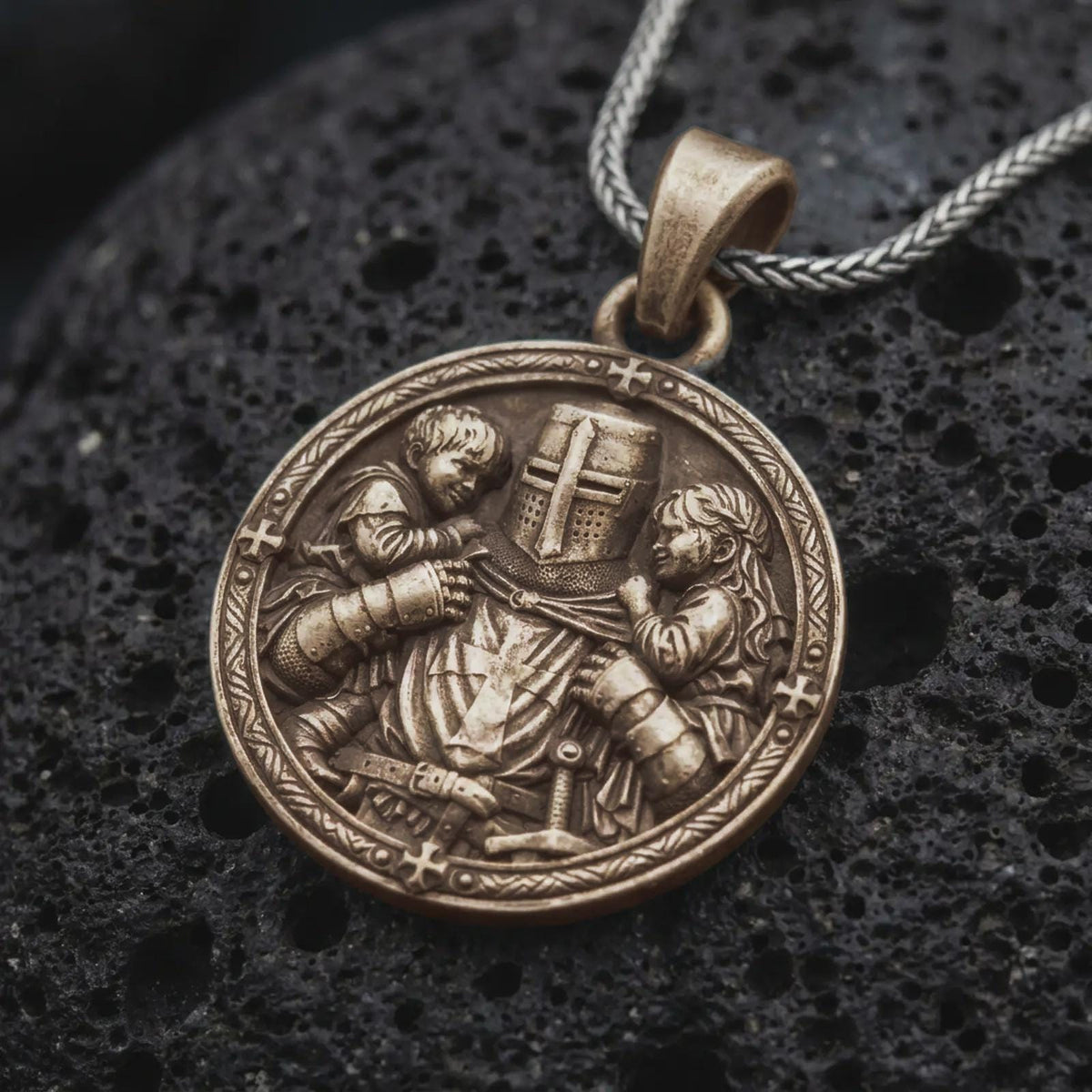 Bronze Templar knight protecting children pendant on black volcanic rock, featuring a cross-marked medieval helmet, armored warrior, two children, and an ornate circular border.