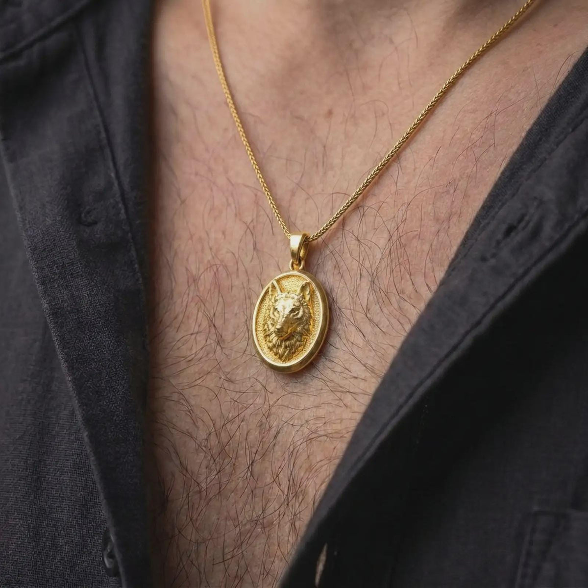 Gold plated wolf necklace worn on the chest, highlighting the detailed wolf face, layered fur, alert expression, and symbolic animal pendant aesthetic.