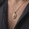 Load image into Gallery viewer, Rose gold plated wolf head necklace worn on the chest, showcasing the sculpted wolf portrait, textured fur, oval medallion, and distinctive wildlife jewelry design.
