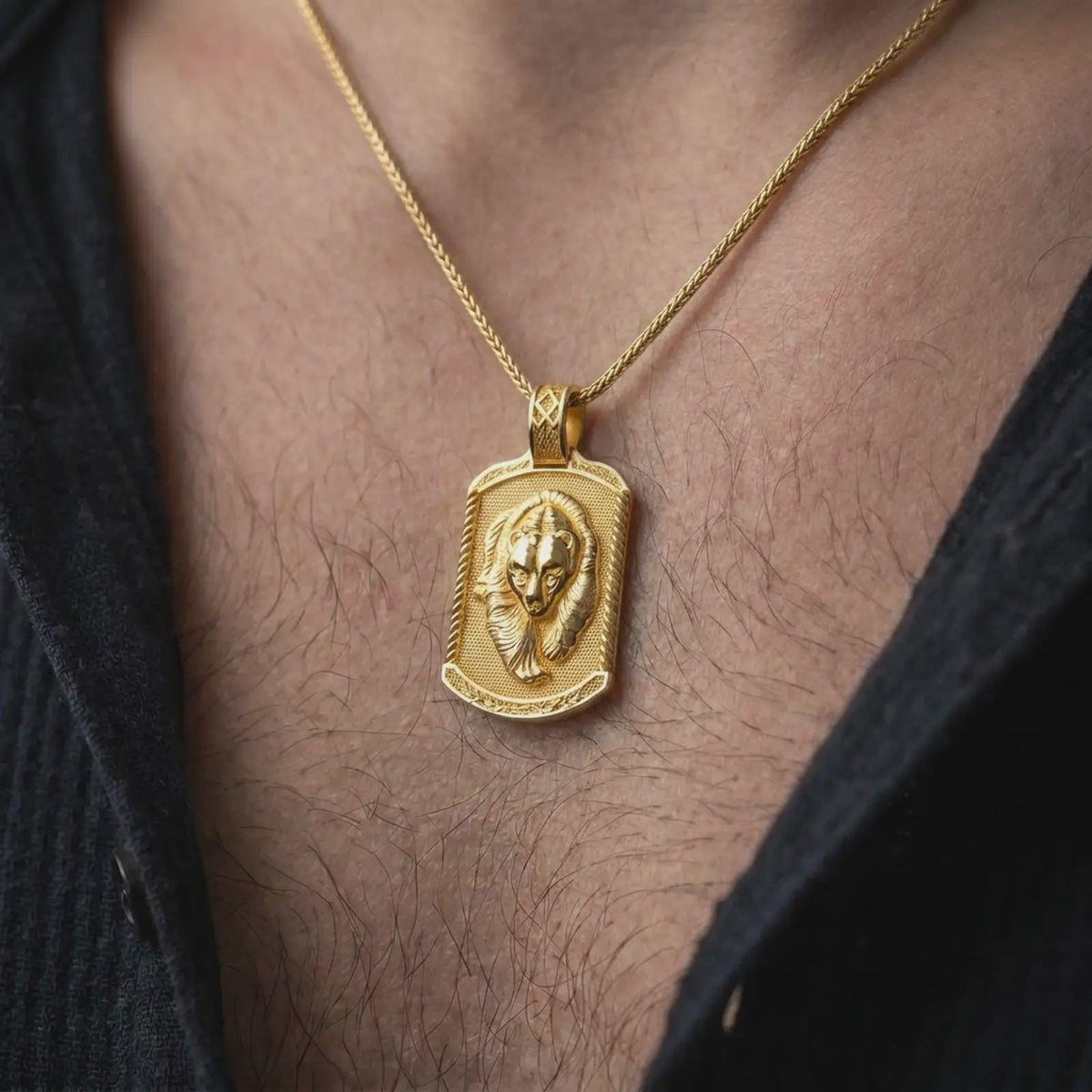 Gold plated bear and cub necklace worn on the chest, highlighting the nestled bear portraits, detailed fur texture, and symbolic family strength and protection jewelry design.