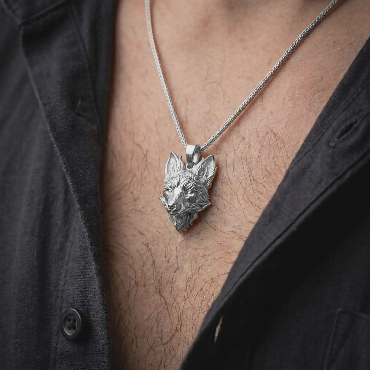 Polished silver fox head pendant worn on the chest, featuring a realistic fox portrait, sculpted facial details, and distinctive nature-inspired necklace styling.