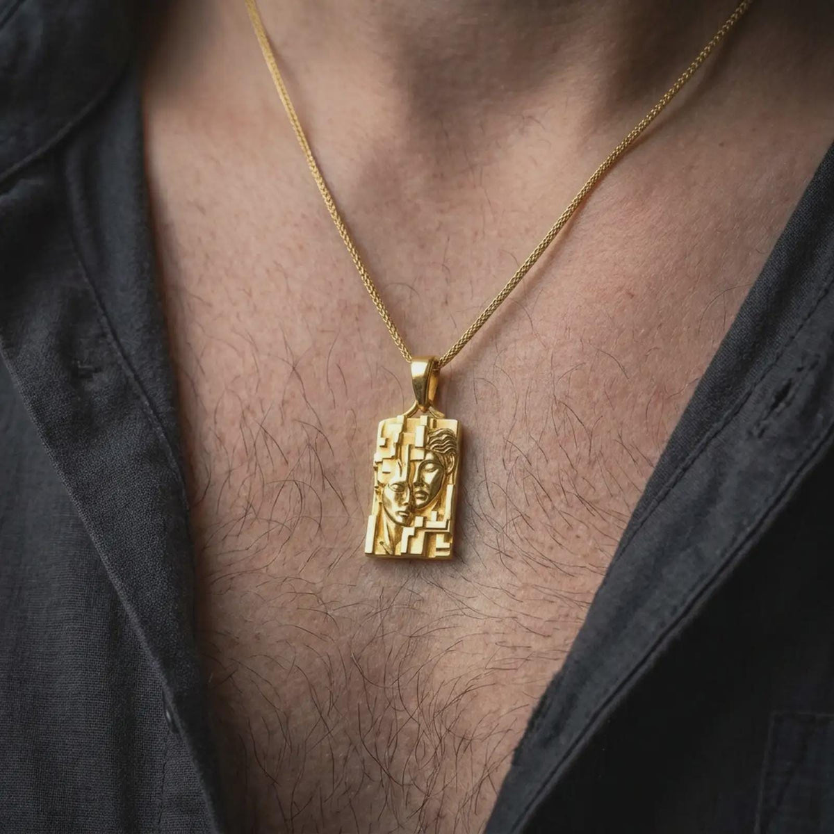 Gold plated Gemini zodiac necklace worn on the chest, highlighting the dimensional twin face portraits, bold geometric frame, and symbolic astrology-inspired pendant design.