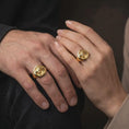 Load image into Gallery viewer, Gold plated lion family ring worn on the finger, highlighting the protective lion and lioness surrounding their cub, intricate mane details, and meaningful father's gift jewelry aesthetic.
