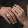 Load image into Gallery viewer, Polished silver lion lioness and cub signet ring worn on the hand, featuring the three sculpted animal portraits, textured background, and symbolic family unity jewelry design.
