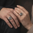 Load image into Gallery viewer, Oxidized sterling silver lion family ring worn on the finger, showing the male lion with flowing mane, lioness leaning toward their cub, and detailed circular signet face symbolizing fatherhood.
