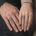 Load image into Gallery viewer, Oxidized sterling silver Skyrim Dragonborn ring worn on the finger, showing the prominent winged dragon emblem, curved neck, open spaces between the wings, and distinctive fantasy RPG jewelry aesthetic.
