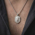 Load image into Gallery viewer, Polished silver feather headdress lion necklace worn on the chest, featuring the dimensional lion head sculpture, detailed layered feathers, powerful facial expression, substantial silver pendant bail, and shield-shaped centerpiece.
