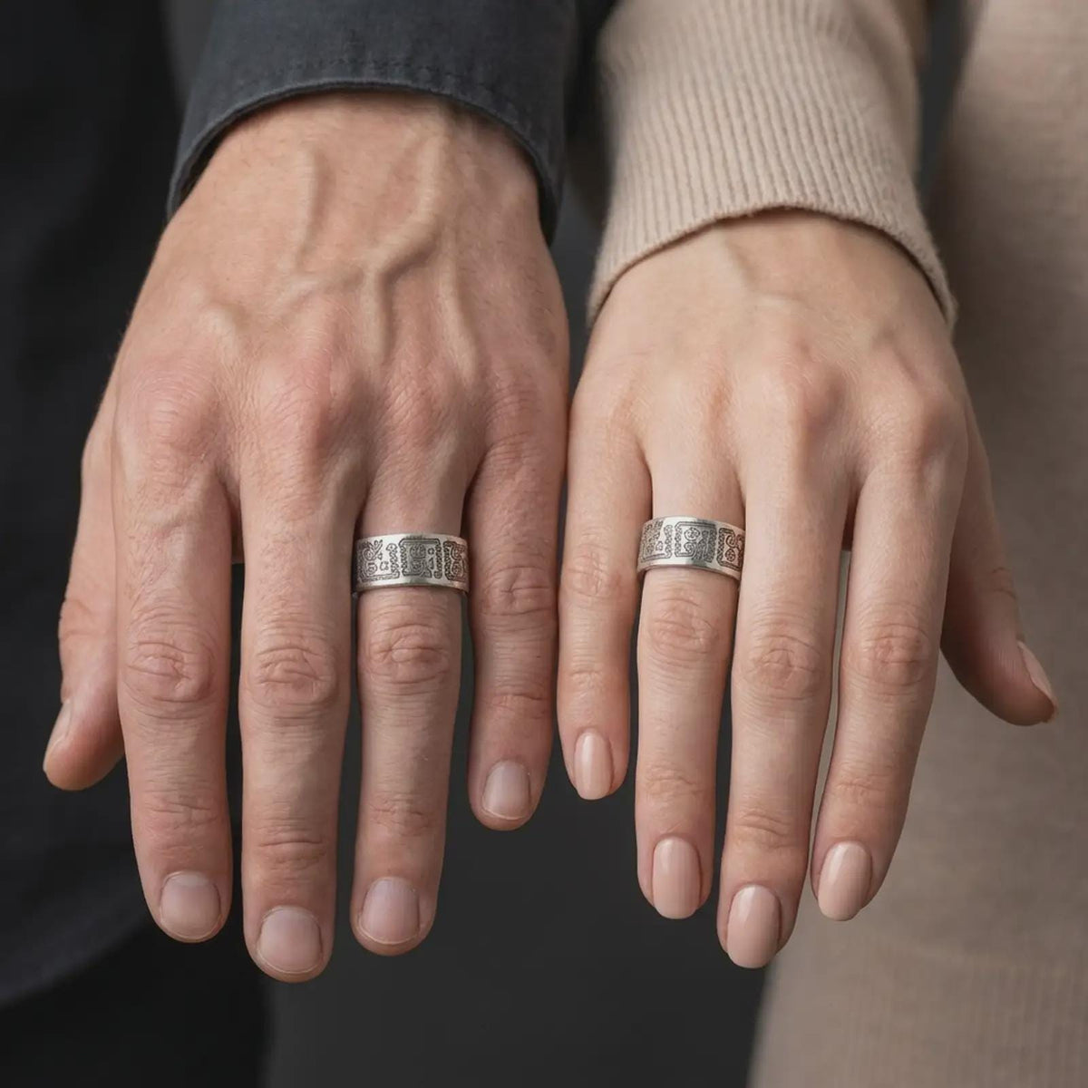 Oxidized 925 sterling silver matching Aztec Mayan rings worn on the fingers of a man and woman together, featuring engraved Mesoamerican-inspired figures, stepped geometric patterns, and coordinated dark oxidized silver finishes.