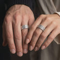 Load image into Gallery viewer, Polished 925 sterling silver matching Viking Valknut rings worn on the fingers of a man and woman together, showcasing repeating interlocking triangle motifs, geometric patterns, and matching bright polished silver finishes.
