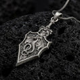 Load image into Gallery viewer, Oxidized 925 sterling silver dragon sword pendant displayed on textured black volcanic rock, featuring a winged dragon coiled around a medieval-style sword blade, intricate scales, decorative hilt, angular edges, and dark oxidized silver finish.
