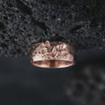 Load image into Gallery viewer, Rose gold plated 925 sterling silver nautical octopus ring displayed against black volcanic stone, highlighting the sculpted octopus head, intricately curved tentacles, raised suction cup details, wide continuous band, and warm rose gold plated finish.
