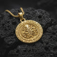 Load image into Gallery viewer, Gold plated Cthulhu pendant necklace on black volcanic rock, featuring a detailed octopus sigil centerpiece, round medallion form, and eldritch horror jewelry aesthetic.
