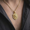 Load image into Gallery viewer, Gold plated grizzly bear necklace worn on the chest, highlighting the detailed bear face, layered fur, shield-shaped medallion, and symbolic strength-inspired jewelry style.
