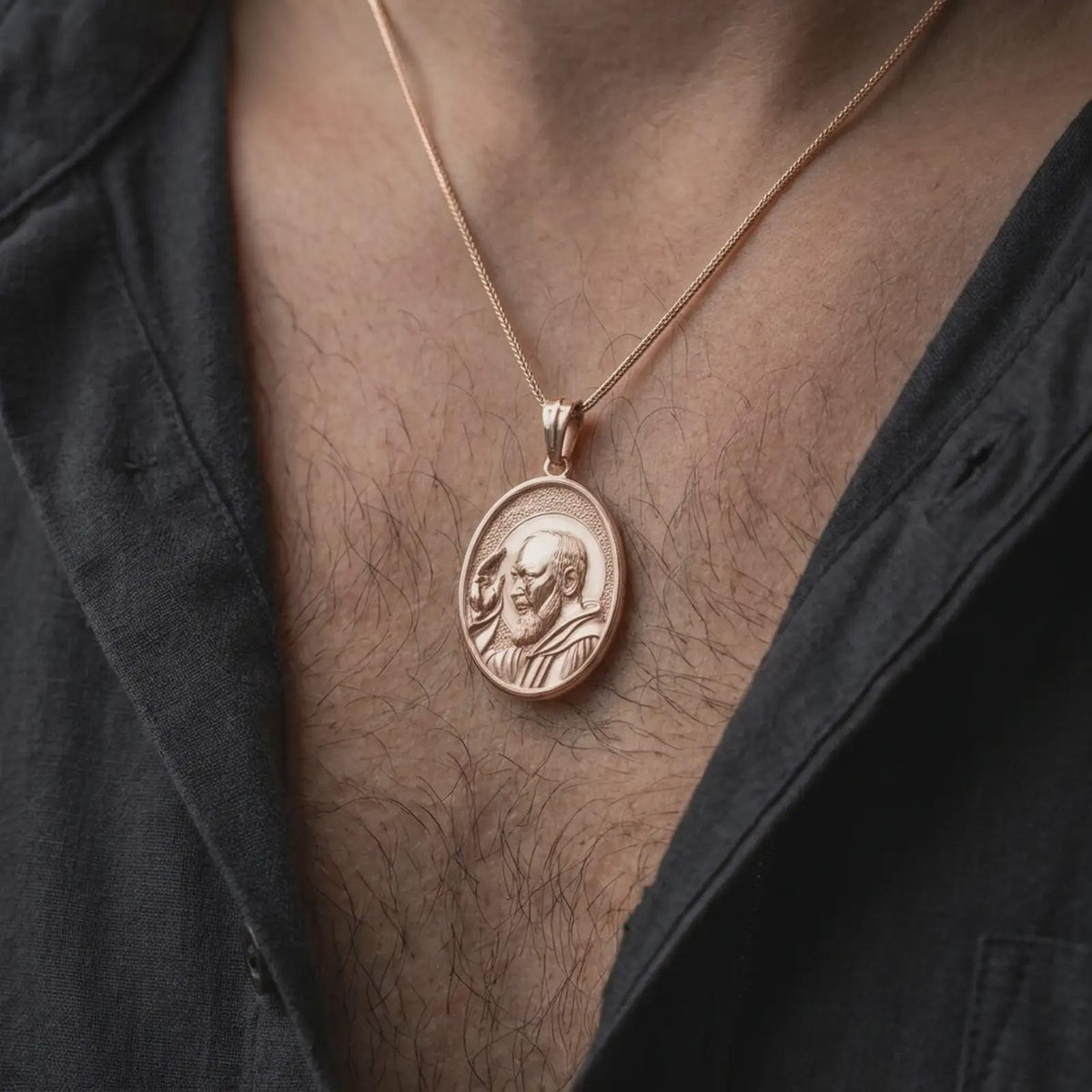 Rose gold plated Saint Pio of Pietrelcina pendant worn on the chest, showcasing the detailed saint portrait, traditional Capuchin habit, oval medallion frame, and Catholic religious jewelry aesthetic.