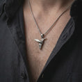 Load image into Gallery viewer, Oxidized sterling silver origami hummingbird necklace worn on the chest, showing the clean geometric bird silhouette, pointed beak, and modern minimalist pendant style.
