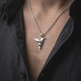 Load image into Gallery viewer, Polished silver hummingbird pendant worn as a necklace, featuring the angular origami bird design and refined contemporary look for everyday wear.
