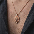 Load image into Gallery viewer, Rose gold plated lion head pendant worn on the chest, showcasing the calm lion expression, detailed flowing mane, raised shield border, and distinctive symbolic animal necklace design.
